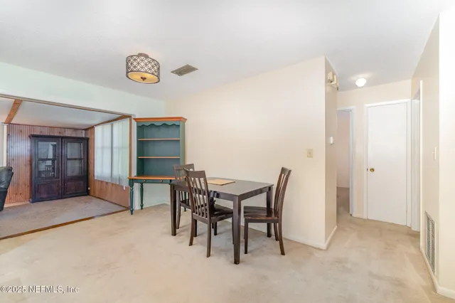 a view of a dining room with furniture and window