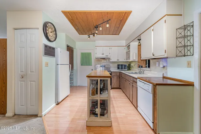 a kitchen with stainless steel appliances granite countertop a stove and a refrigerator