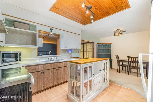 a kitchen with a stove a sink and a refrigerator