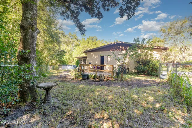 a view of a house with backyard porch and sitting area
