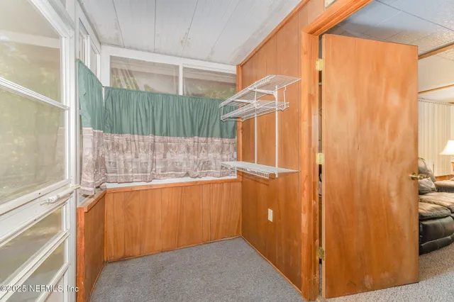 a view of a closet area with wooden floor
