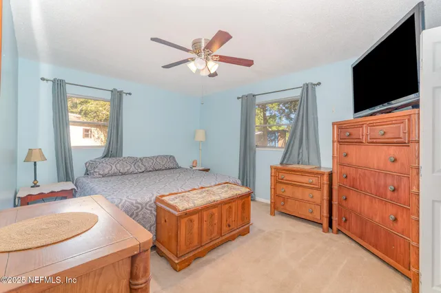 a bedroom with bed and a flat screen tv