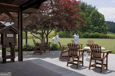 a view of a patio with table and chairs next to a yard