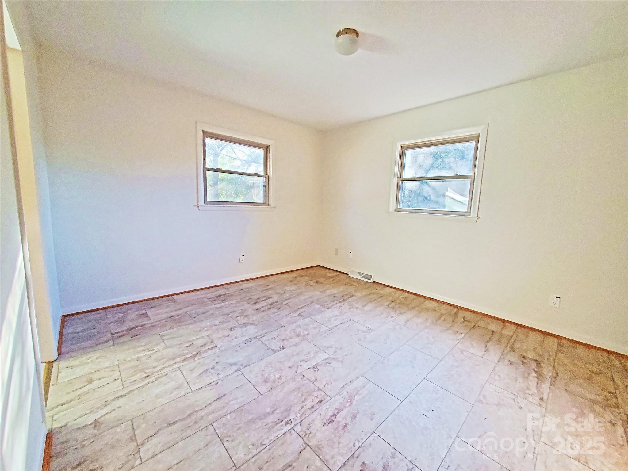 1303 Hunt Street Shelby, NC 28152 - Photo 8 of 16 an empty room with wooden floor and window