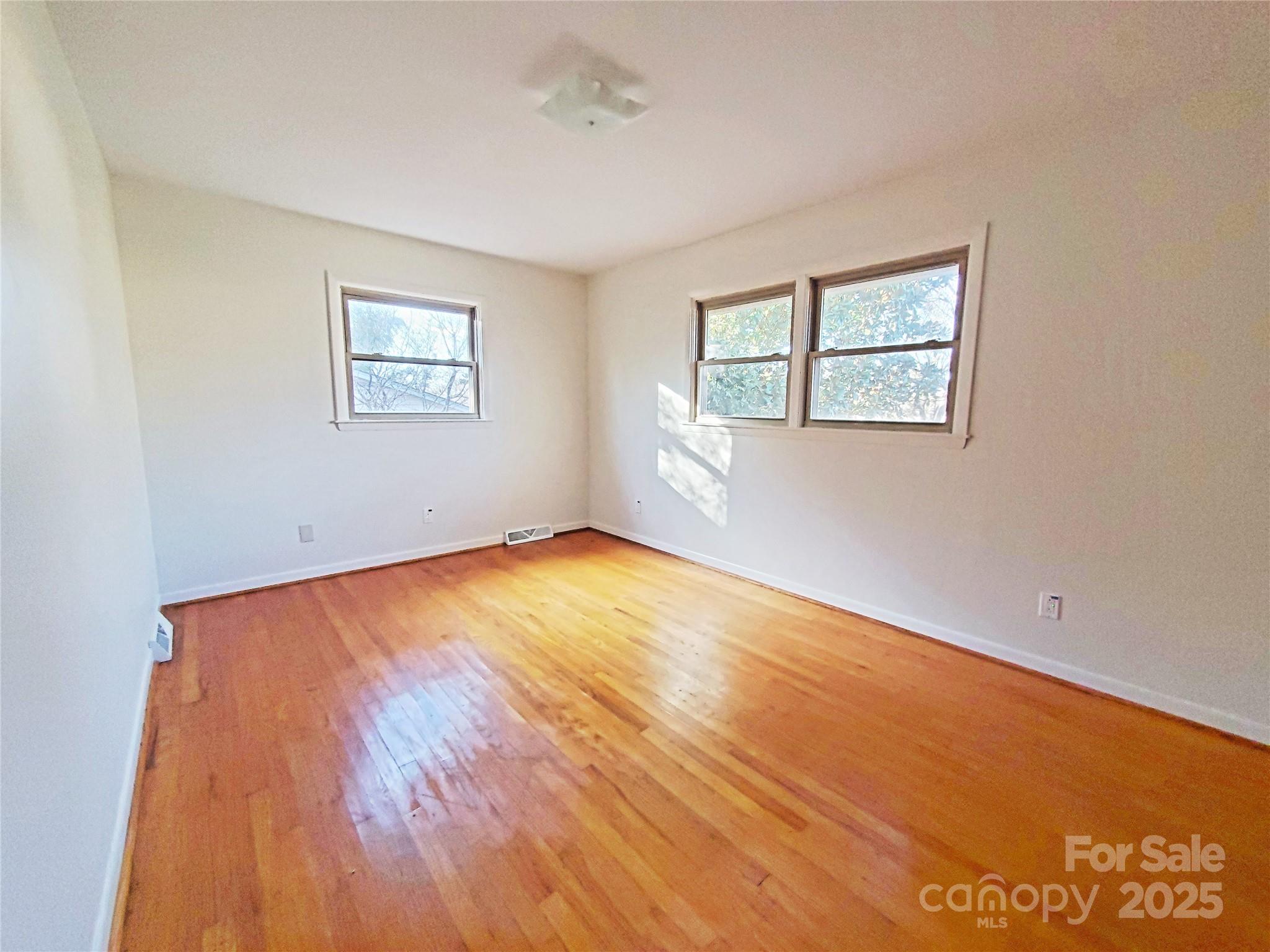 1303 Hunt Street Shelby, NC 28152 - Photo 10 of 16 an empty room with a window and wooden floor