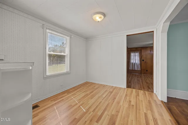 a view of a room with wooden floor and a window