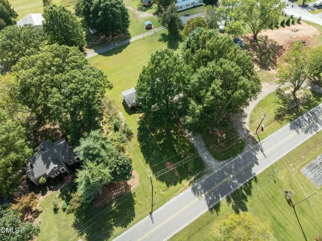 an aerial view of residential houses with outdoor space and river
