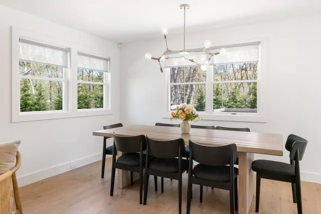 a dining room with furniture a chandelier and window