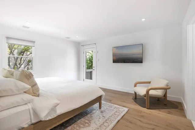 a bedroom with a bed and a flat screen tv