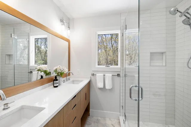 a bathroom with a sink vanity tub and shower