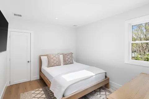 a bedroom with a bed and a window