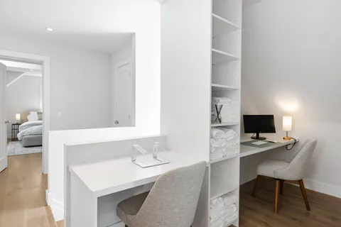 a workspace with furniture and bathroom