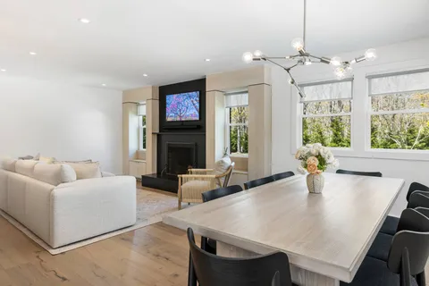 a living room with fireplace furniture and a chandelier