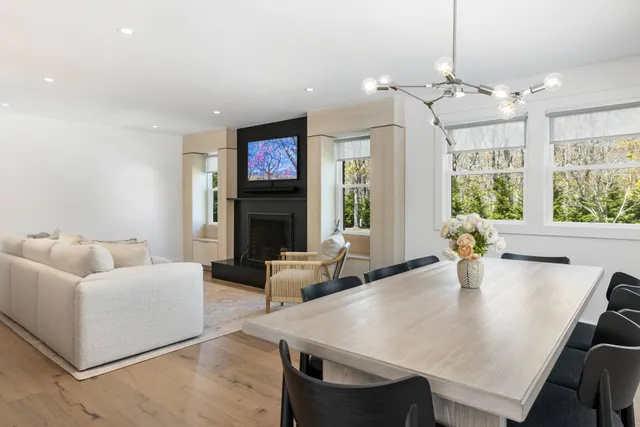 a living room with fireplace furniture and a chandelier