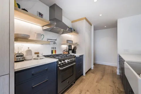 a kitchen with a sink stove and cabinets