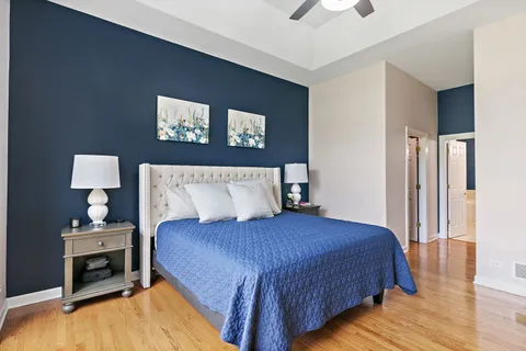 a bedroom with a bed and a night stand