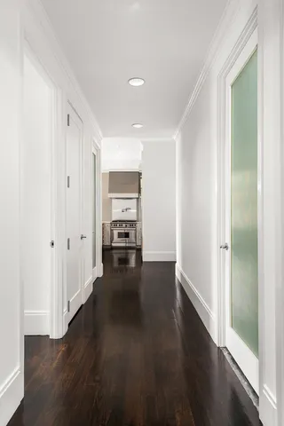 a view of a room with wooden floor and white walls