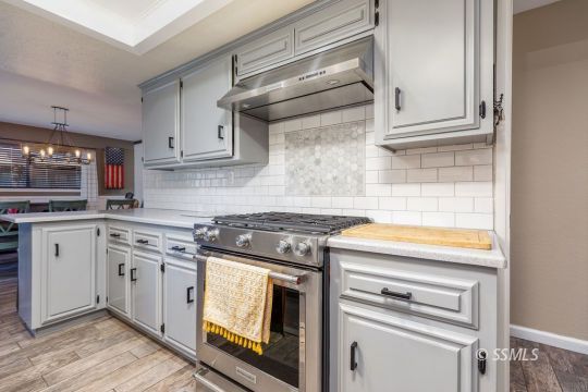 1116 South Allen Street Ridgecrest, CA 93555 - Photo 14 of 33 a kitchen with white cabinets and appliances