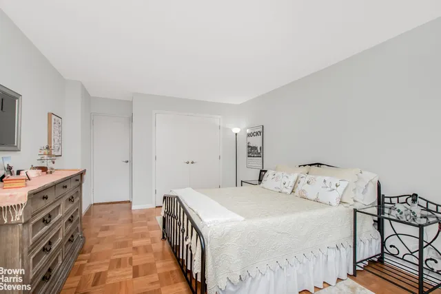 a bed room with a bed and a chair