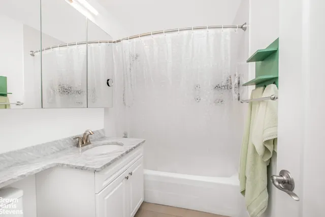 a spacious bedroom with a bed and a cabinets