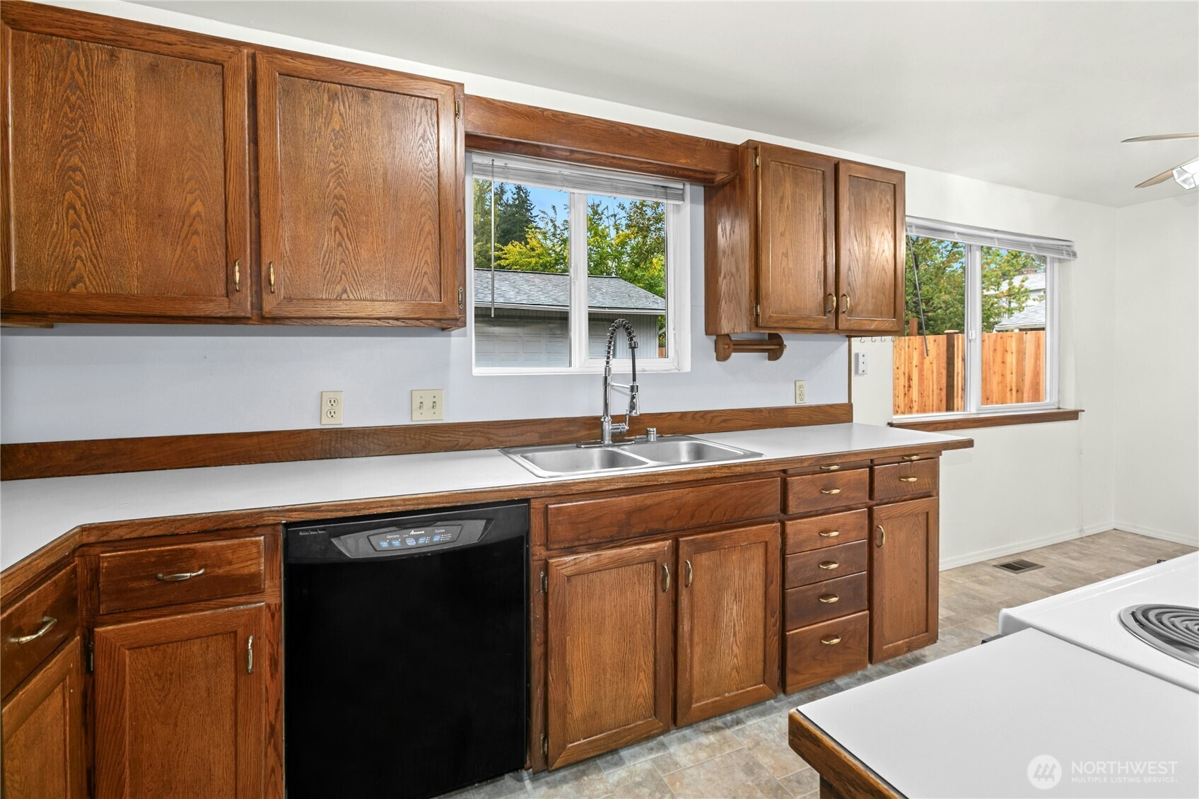 15914 52nd Avenue West Edmonds, WA 98026 - Photo 19 of 29 a kitchen with stainless steel appliances granite countertop a sink a stove and a microwave