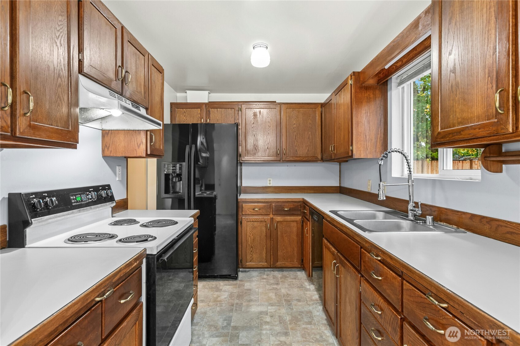 15914 52nd Avenue West Edmonds, WA 98026 - Photo 7 of 29 a kitchen with stainless steel appliances granite countertop a sink stove and refrigerator
