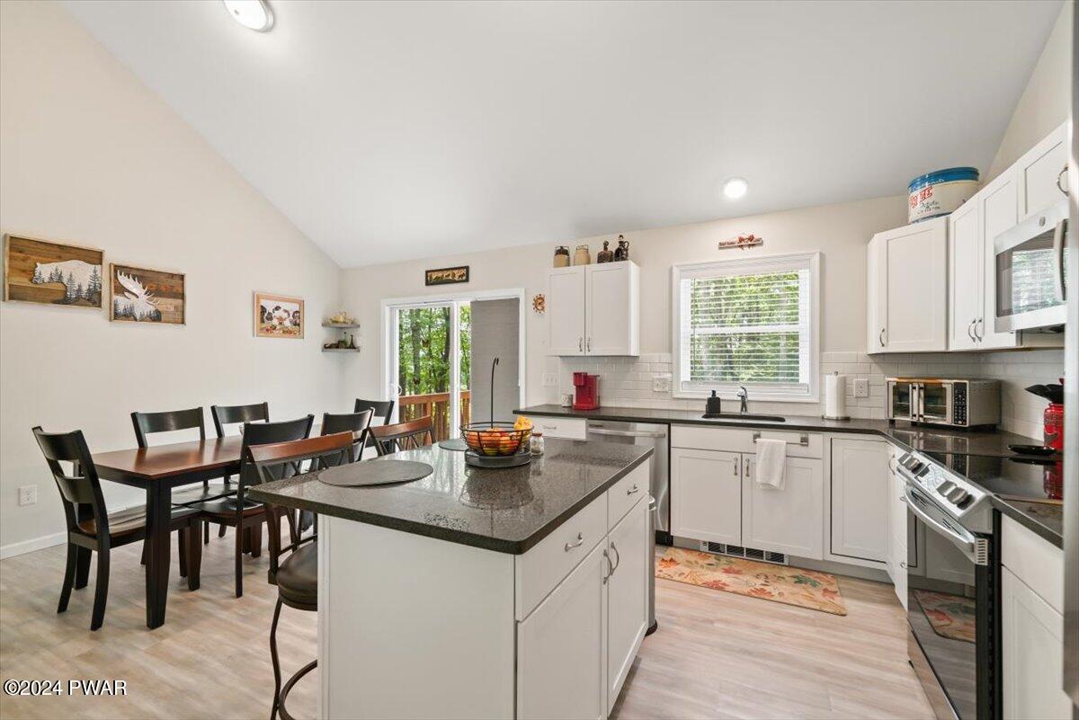 133 Butternut Road Milford, PA 18337 - Photo 11 of 34 a kitchen with a stove a sink a dining table and chairs