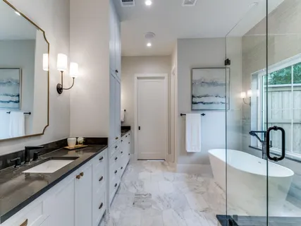 a bathroom with a granite countertop sink mirror and double