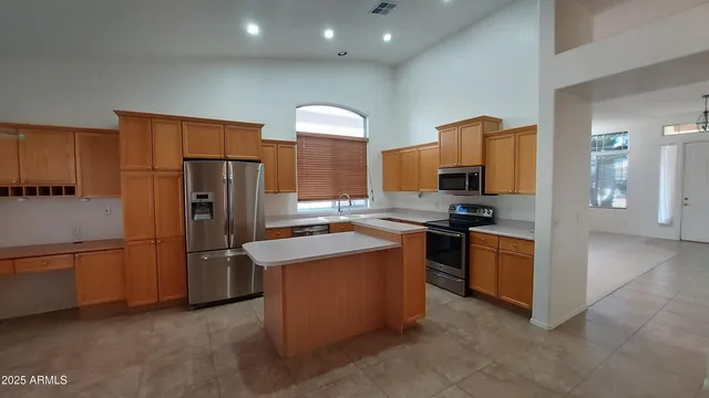 a kitchen with stainless steel appliances granite countertop a refrigerator stove and oven