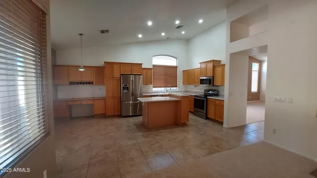 a kitchen with refrigerator and cabinets