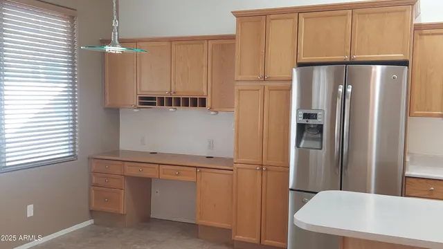 a kitchen with cabinets and stainless steel appliances