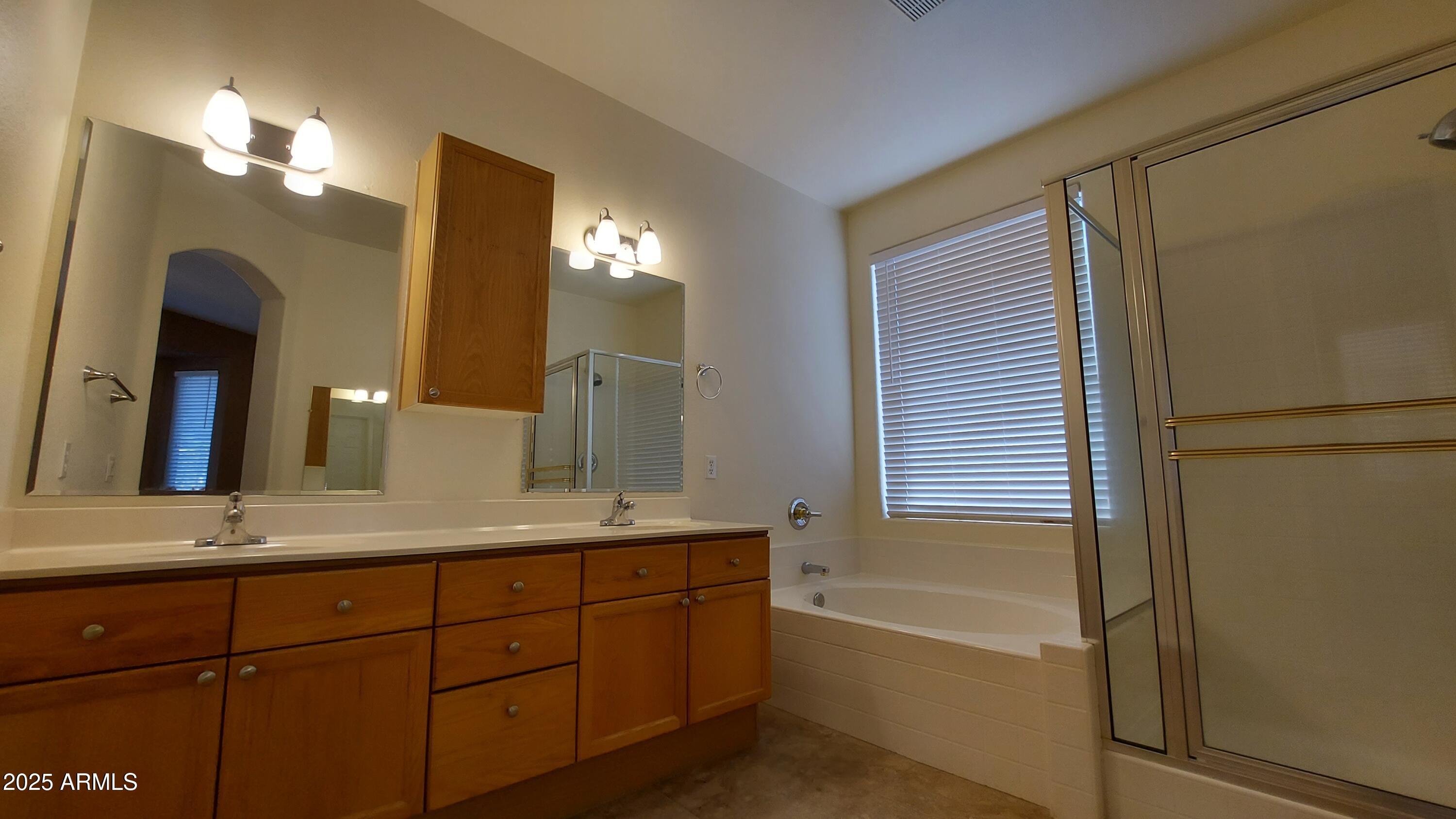 740 North Nantucket Street Chandler, AZ 85225 - Photo 8 of 13 a bathroom with a granite countertop sink mirror and a bathtub