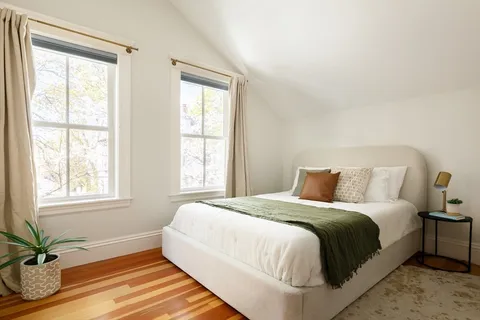 a bedroom with a bed and window