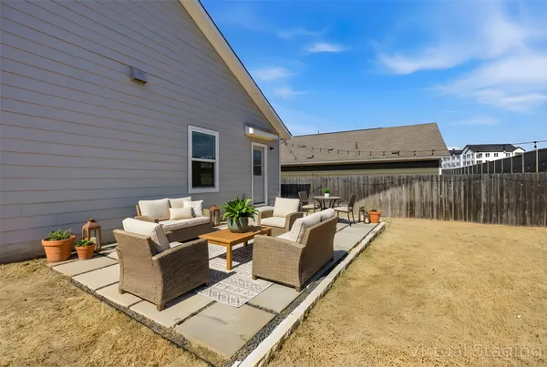 a roof deck with couches and wooden floor
