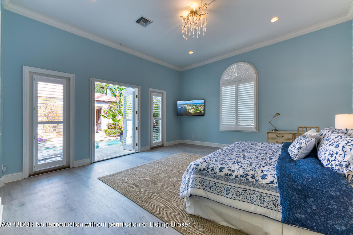 2258 Ibis Isle Road East Palm Beach, FL 33480 - Photo 21 of 31 a bedroom with a large bed and a window