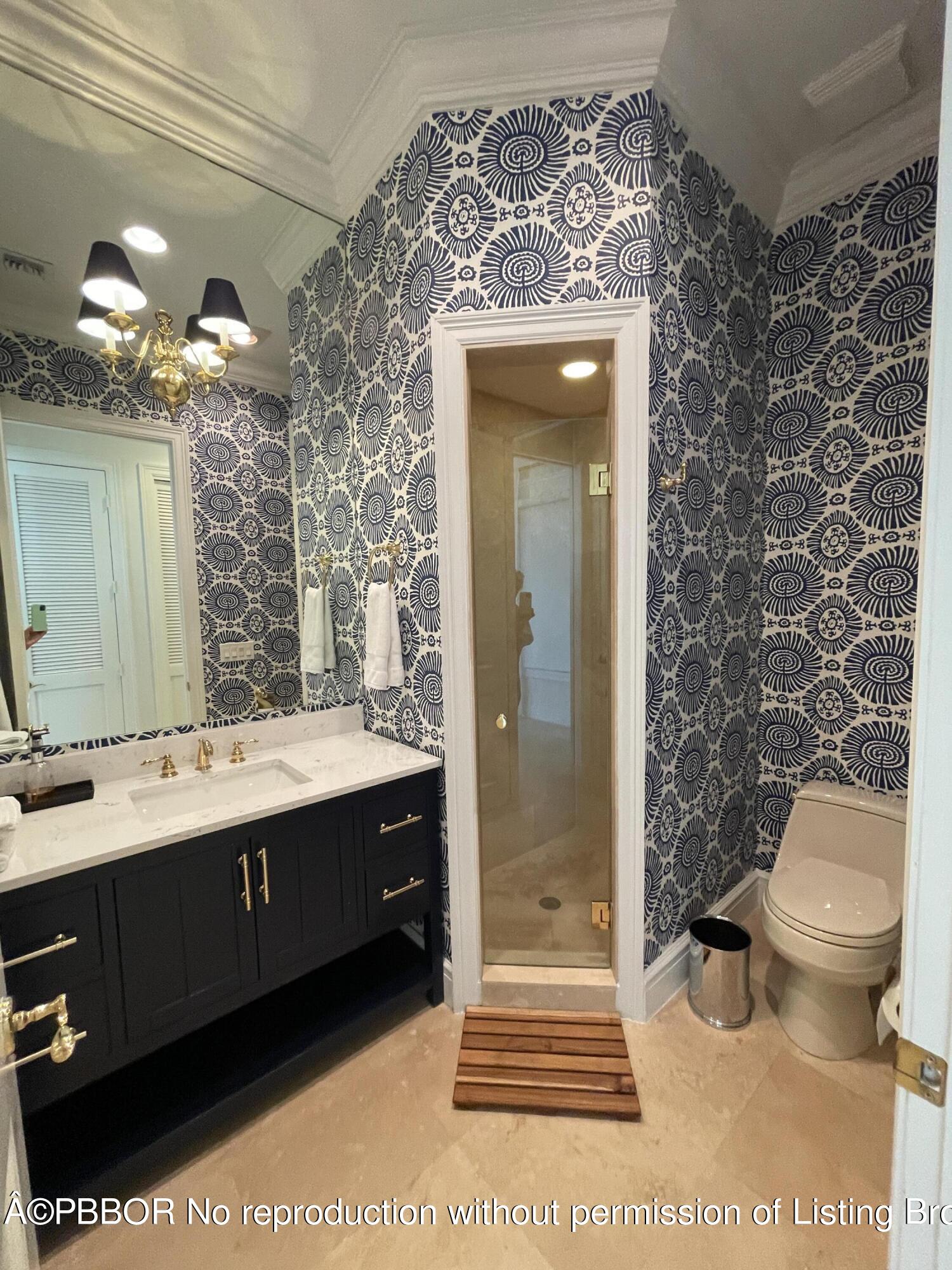 2258 Ibis Isle Road East Palm Beach, FL 33480 - Photo 25 of 31 a bathroom with a sink a toilet and shower