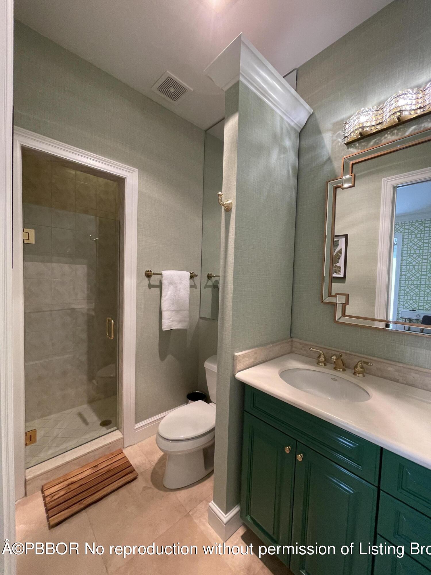 2258 Ibis Isle Road East Palm Beach, FL 33480 - Photo 28 of 31 a bathroom with a sink a toilet and shower