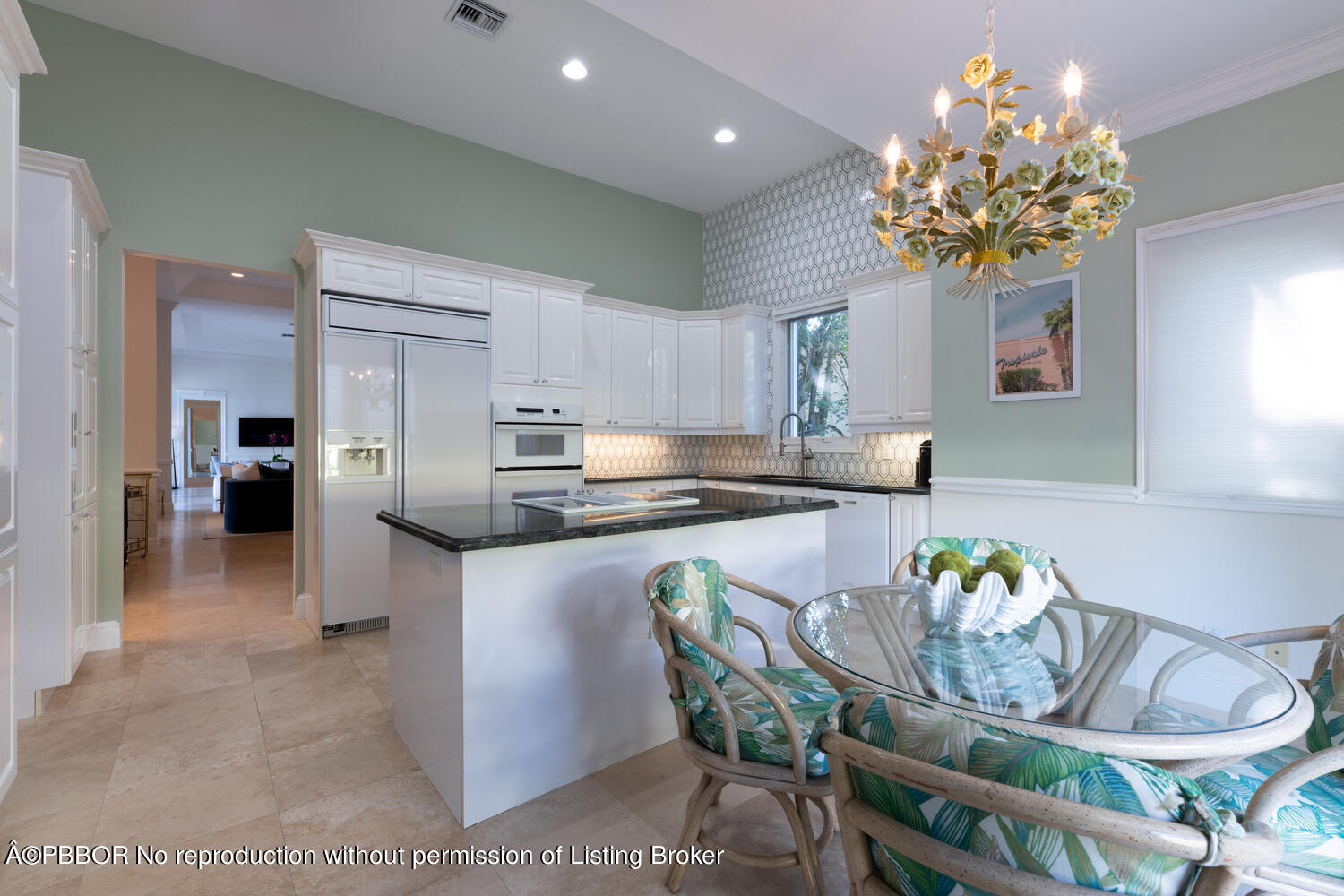 2258 Ibis Isle Road East Palm Beach, FL 33480 - Photo 30 of 31 a kitchen with stainless steel appliances granite countertop a kitchen island a stove a dining table and chairs