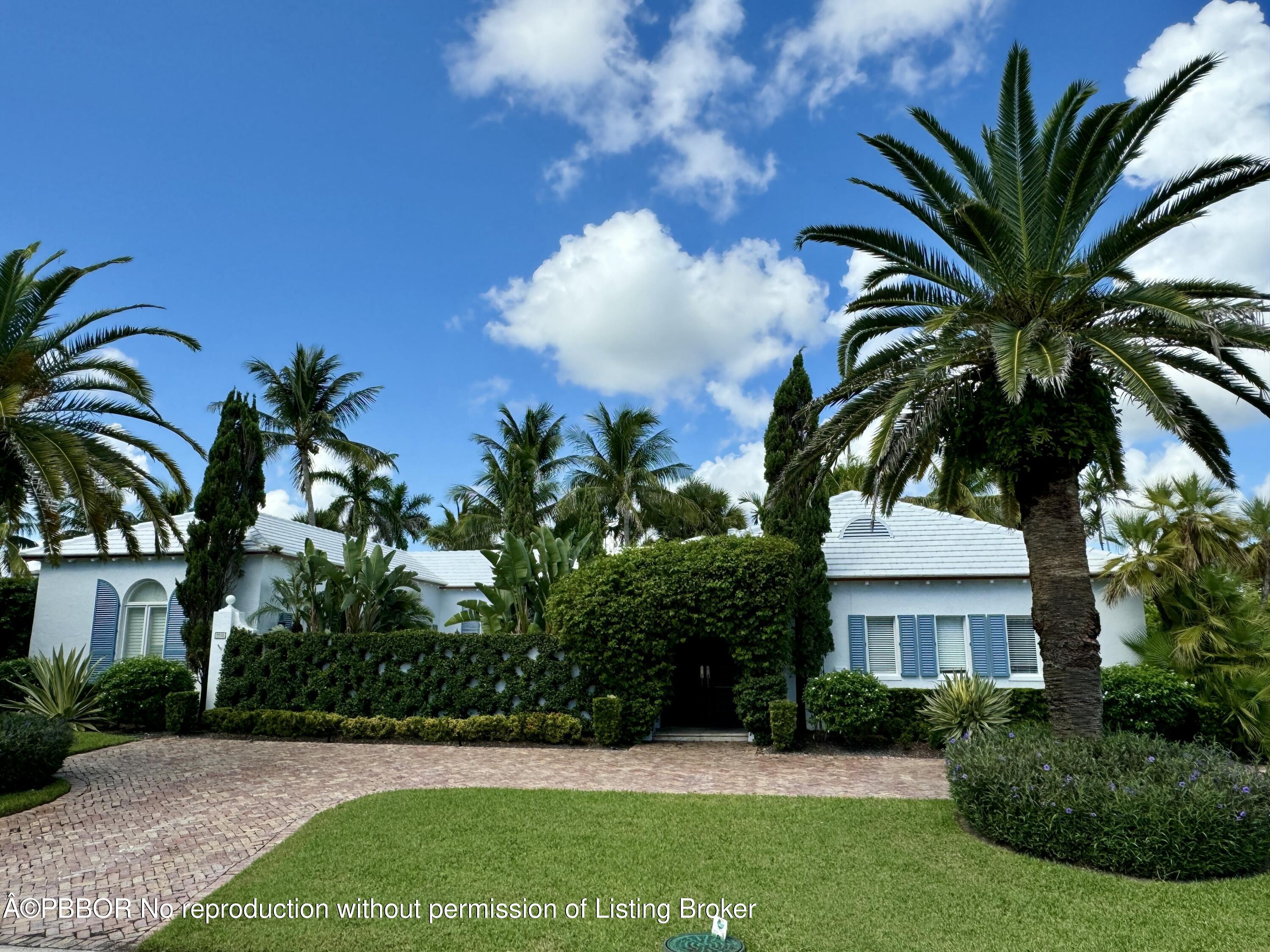 2258 Ibis Isle Road East Palm Beach, FL 33480 - Photo 3 of 31 a view of a house with a yard and potted plants