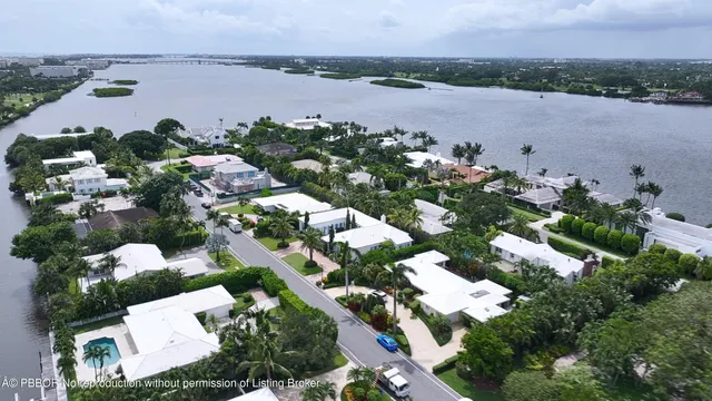 an aerial view of a residential houses with outdoor space and river