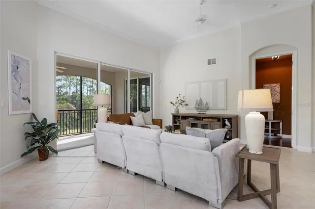 a dining room with furniture a livingroom and chandelier