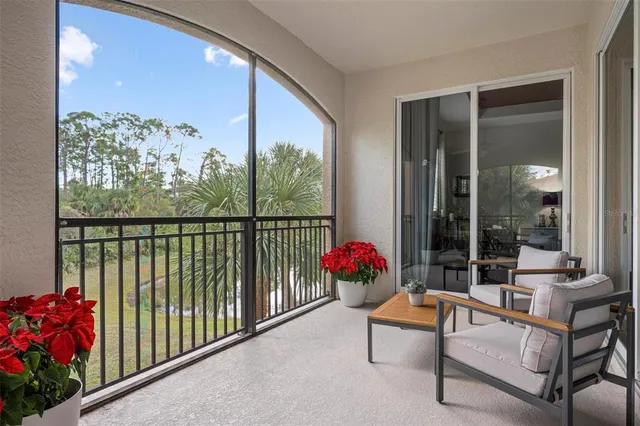a living room with furniture and a refrigerator