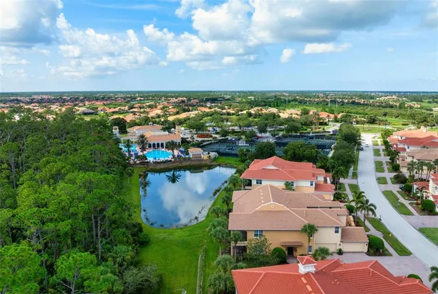 an aerial view of residential houses with outdoor space and ocean view