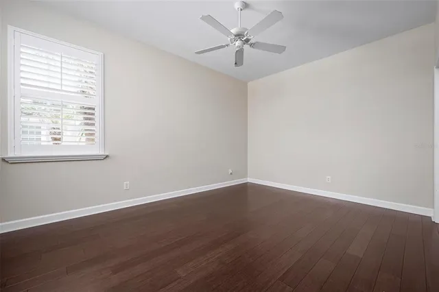 an aerial view of a house with a yard and a large tree