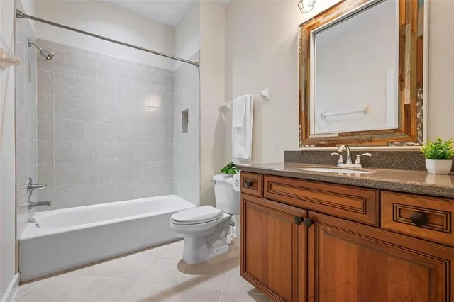 a view of a swimming pool with lawn chairs under an umbrella