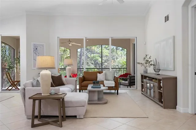 a living room with furniture and a floor to ceiling window