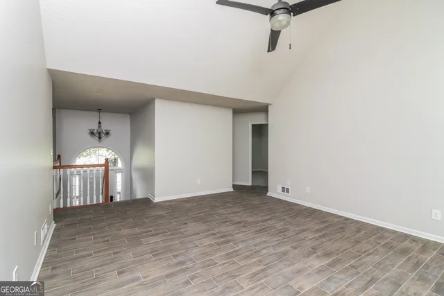 a view of empty room with wooden floor