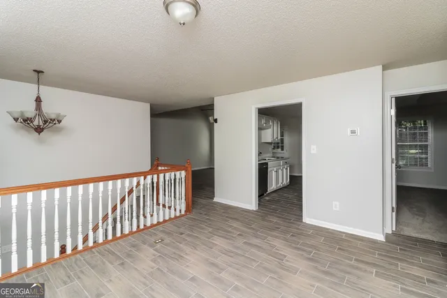a view of hallway with wooden floor