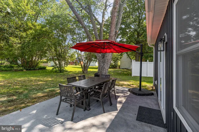 a view of a patio with a table chairs and a table