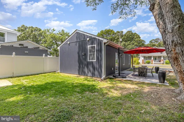 a view of a house with backyard porch and sitting area